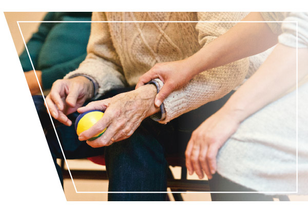 Practitioner Holding Patient's Hand who is holding a ball